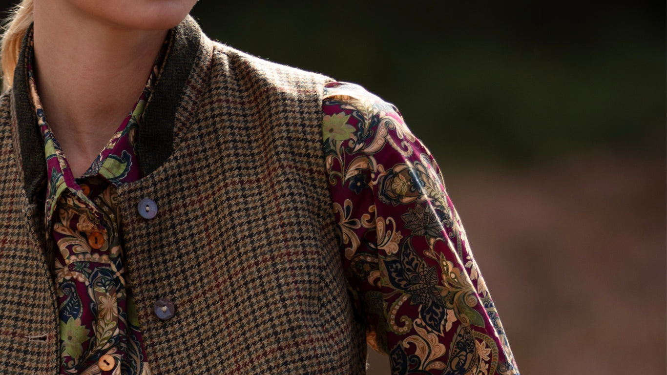 Dogtooth waistcoat worn open over a claret shirt