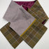 A folded tweedscarf shown on a plain white background, in a muted lavender-gray herringbone and an olive-brown plaid.